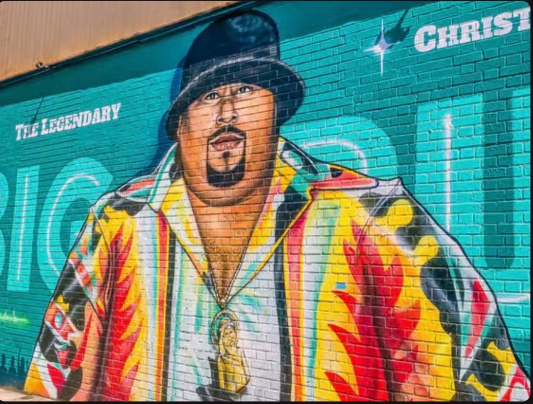 Colorful Bronx portrait mural on a teal brick wall